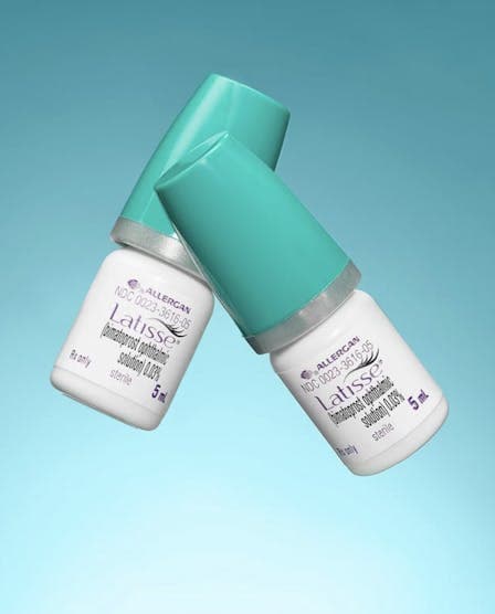 Two bottles of beauty products in front of a blue background