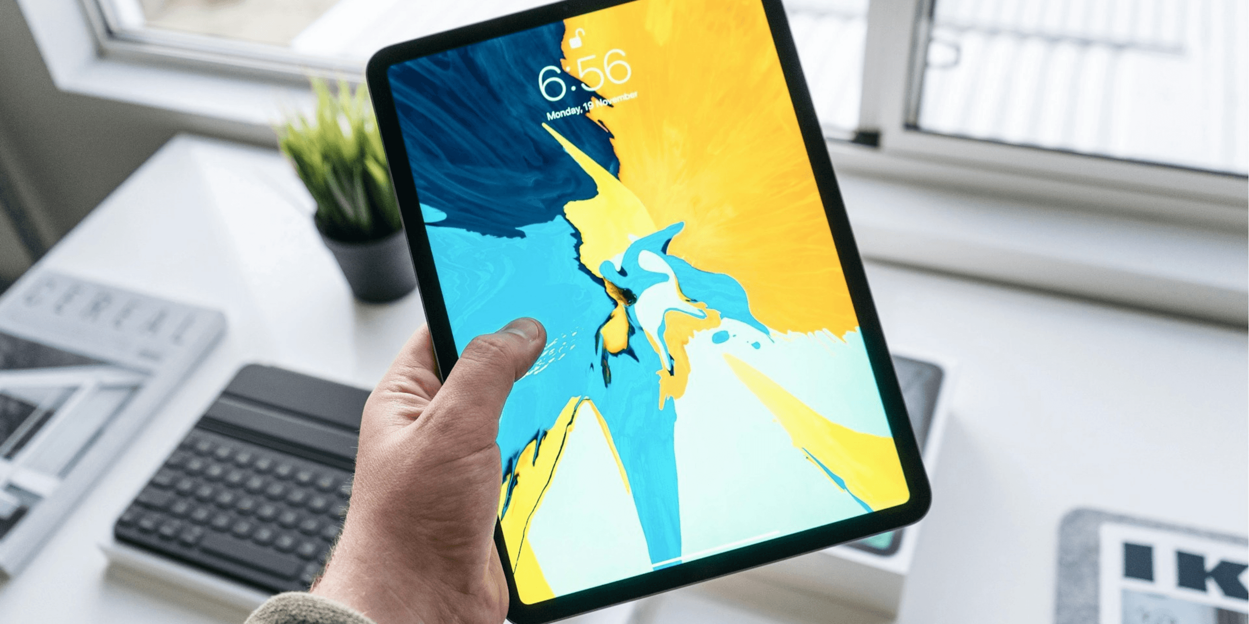 a hand holding a tablet