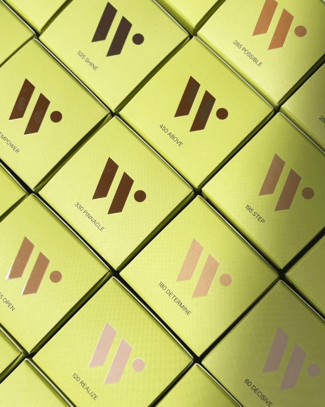 A grid of yellow boxes, each featuring a logo and a word such as "SHINE," "POSSIBLE," and "DETERMINE," printed alongside a number on each box.