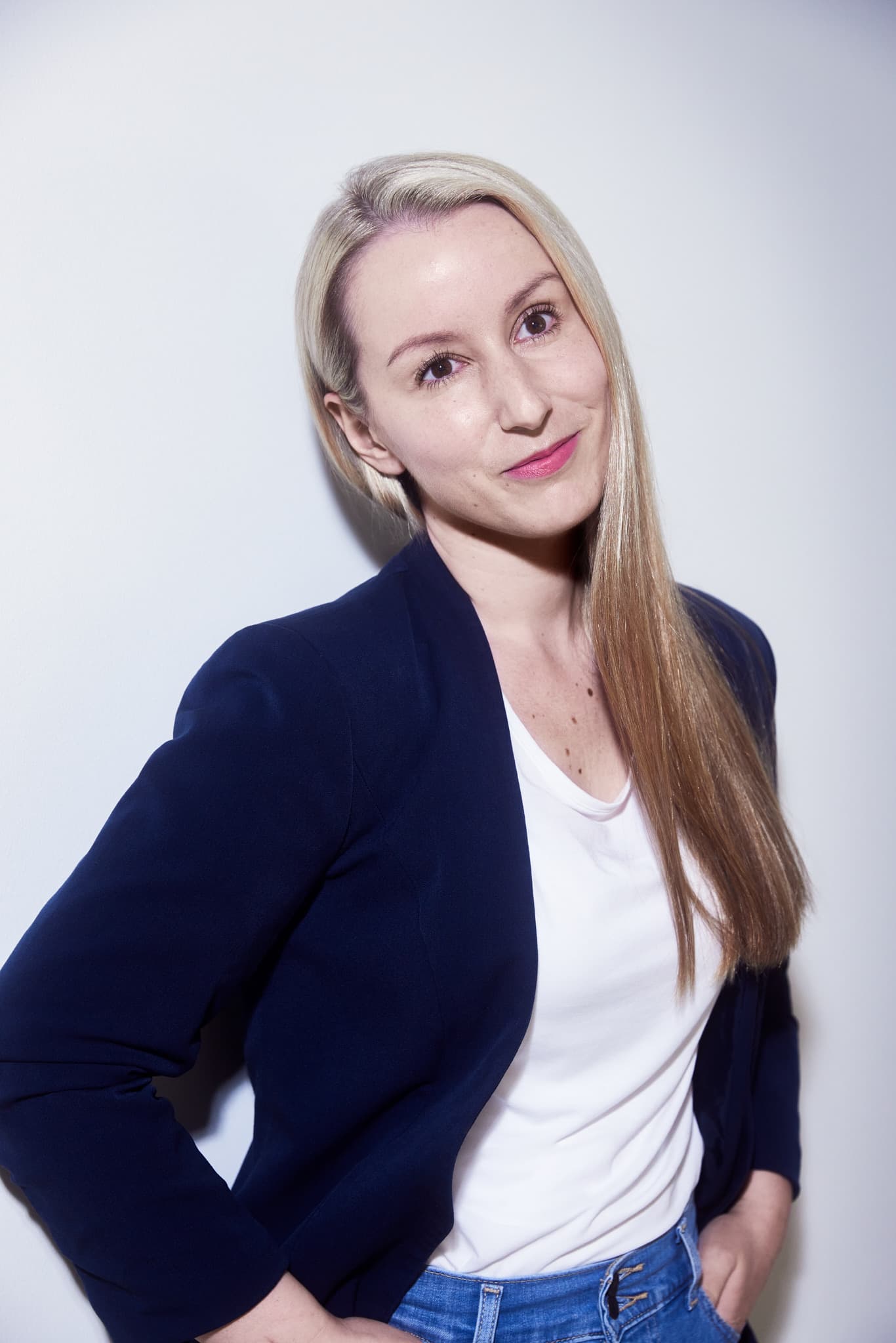 Picture of blonde woman in front of white wall