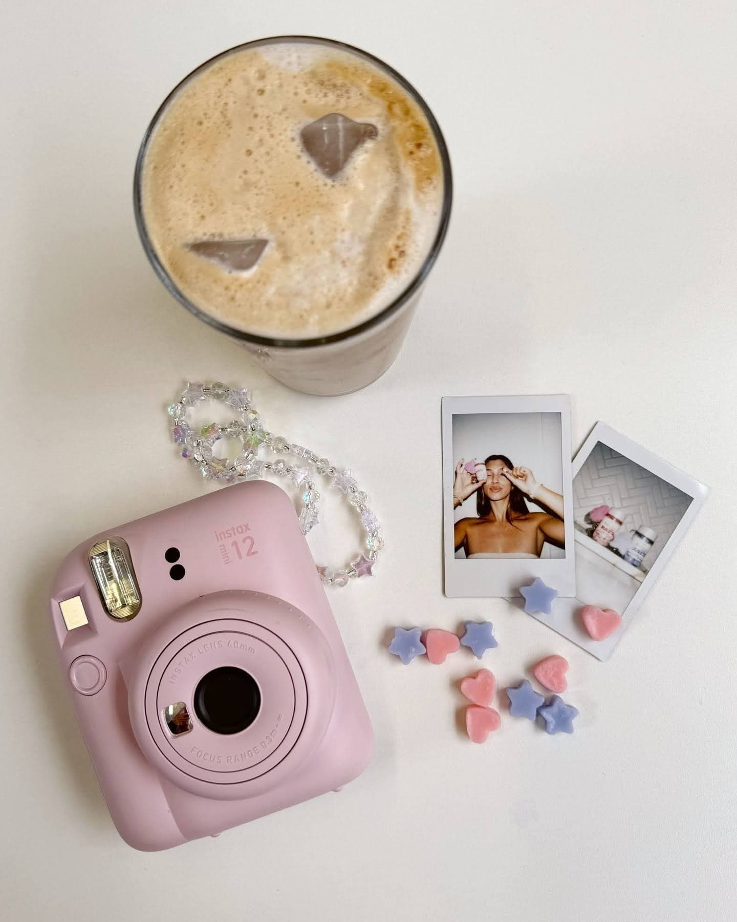Jergens product next to coffee, insta 12 film camera, and developed film