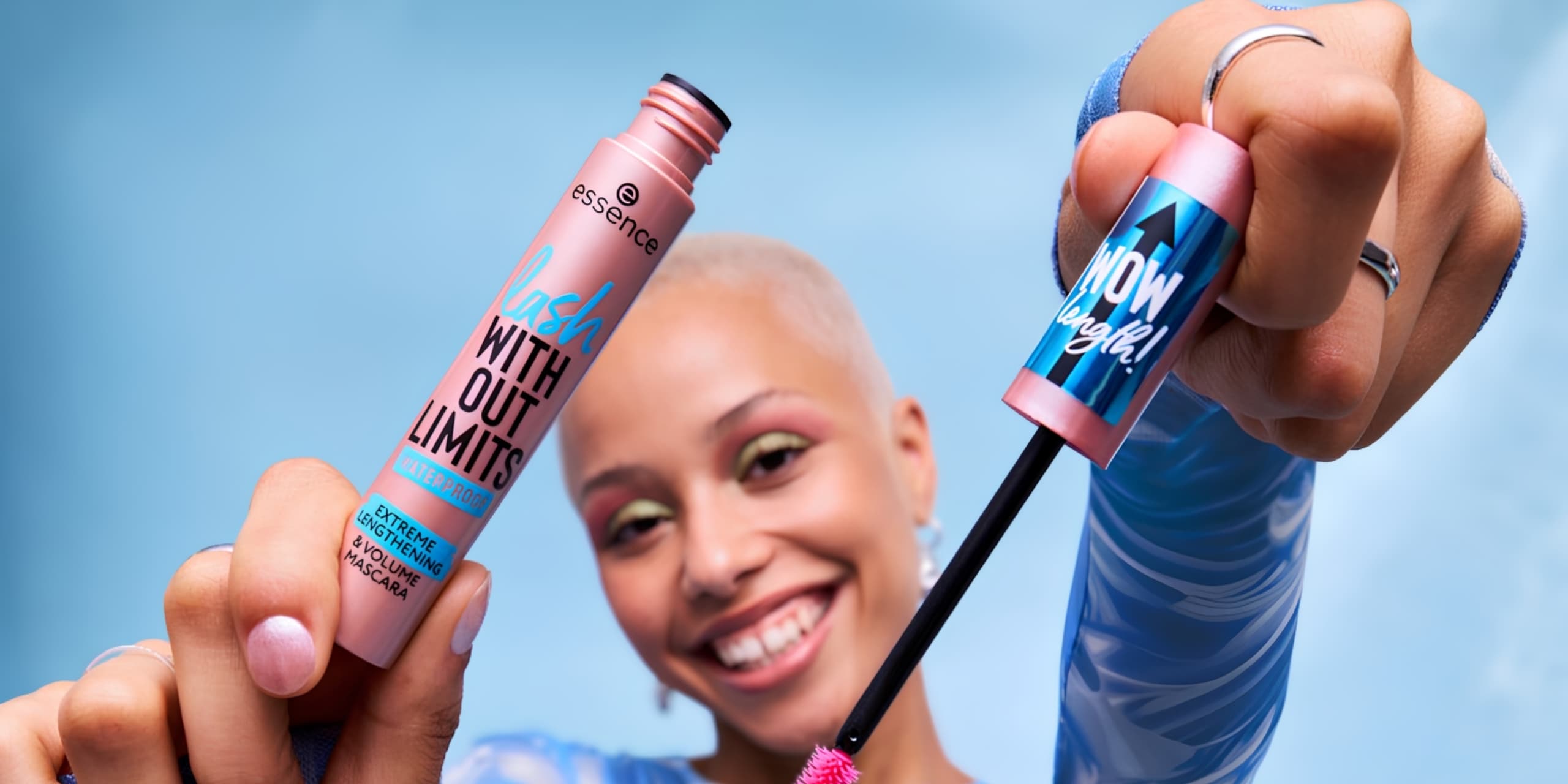 Woman holding essence mascara into the camera