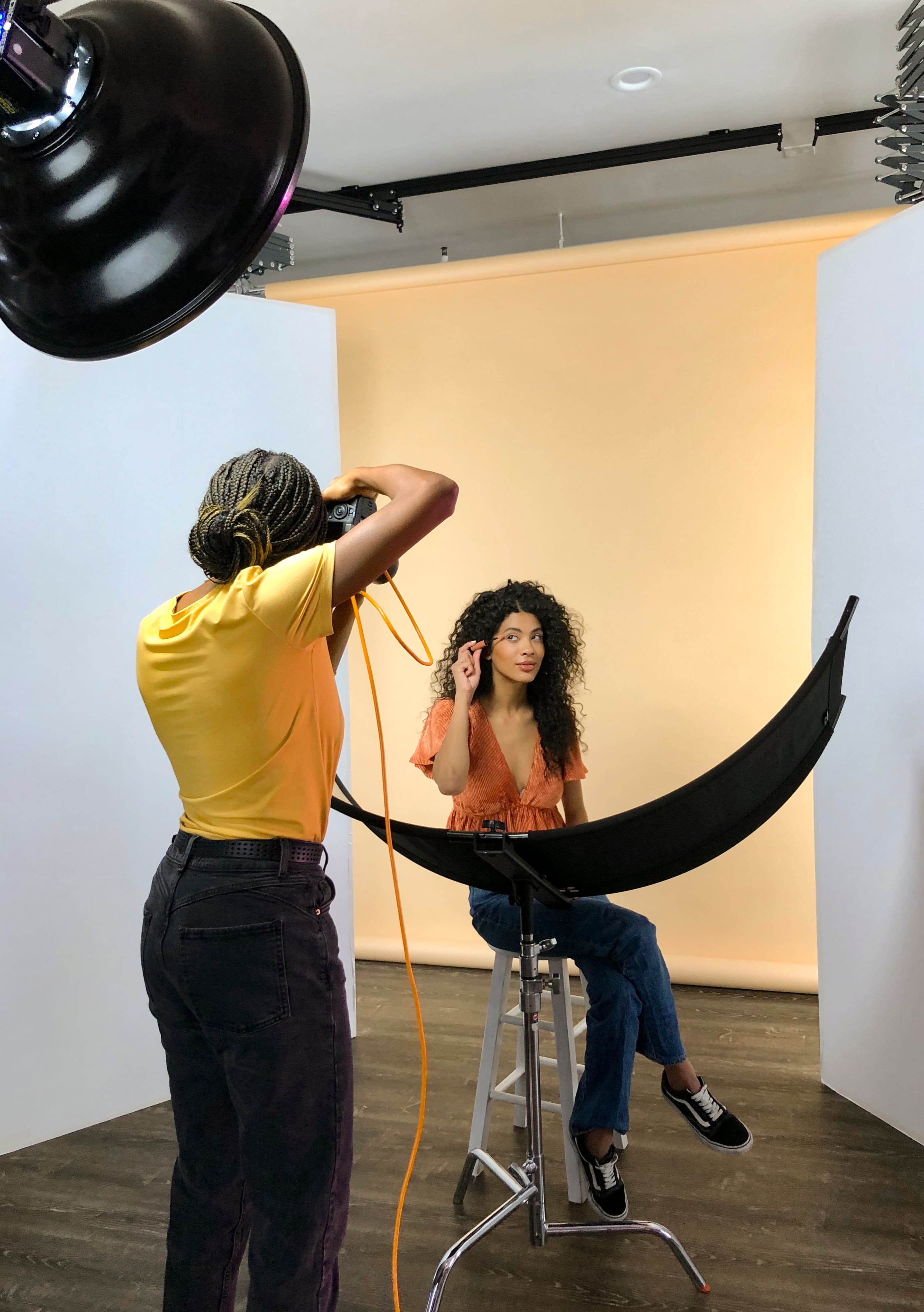 photo shoot with a model applying makeup to her face