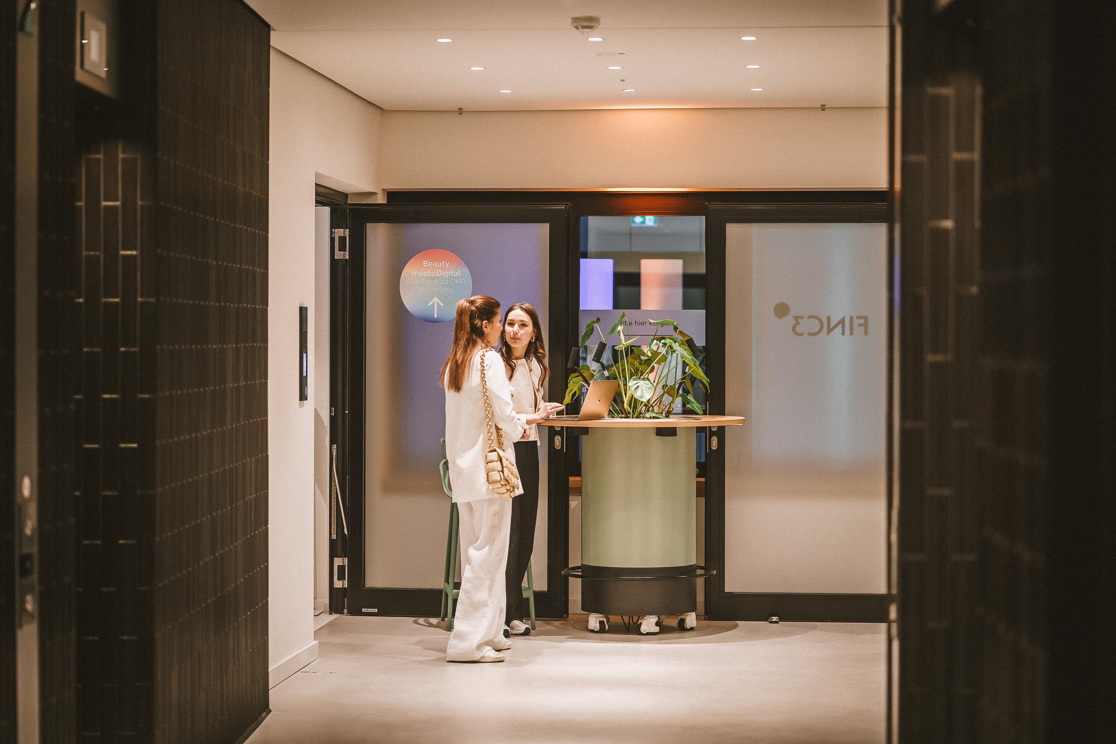 Two employees enjoying a conversation outside of the Front Row Hamburg office