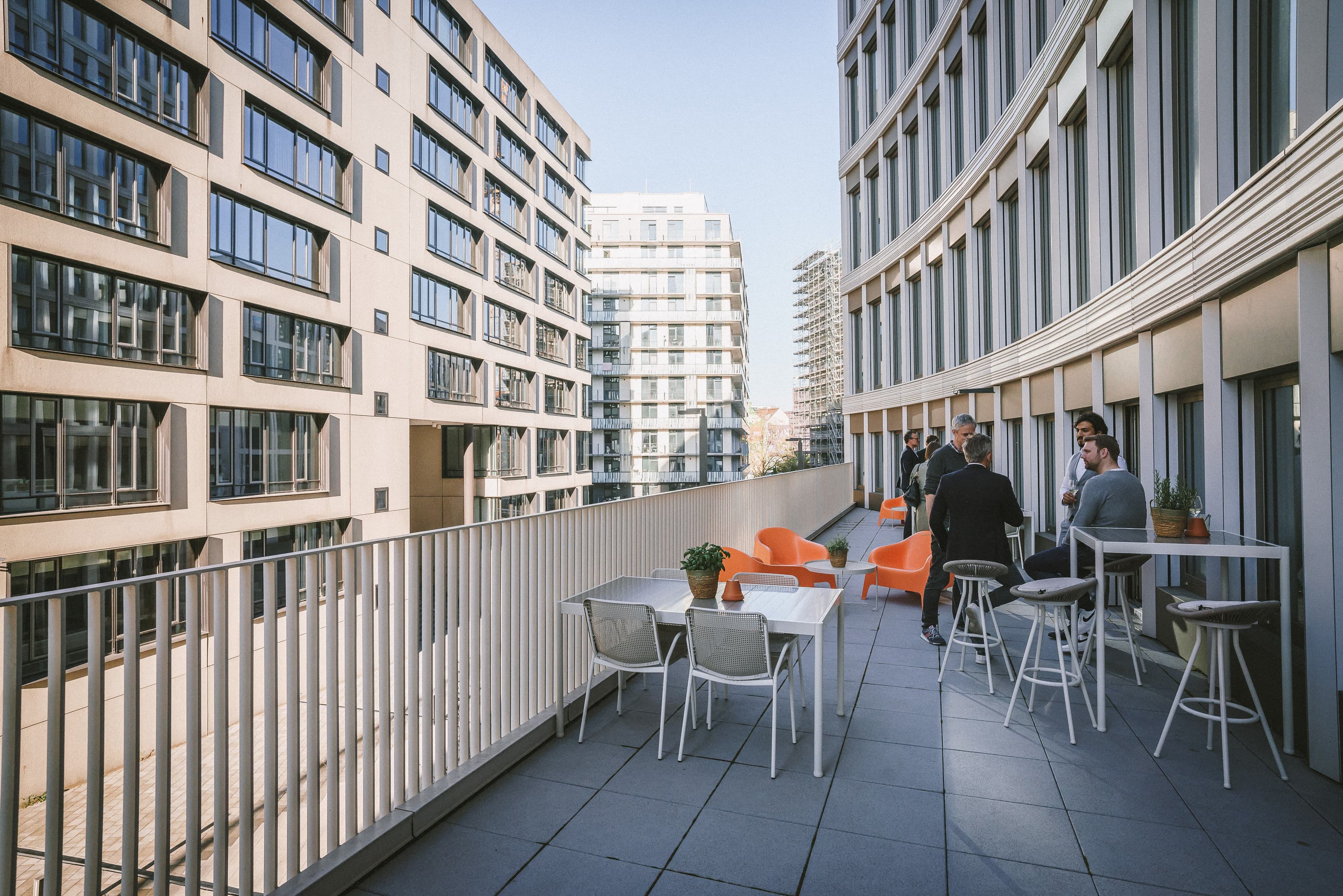 Team members enjoy the outside lounge area at the Front Row Hamburg office