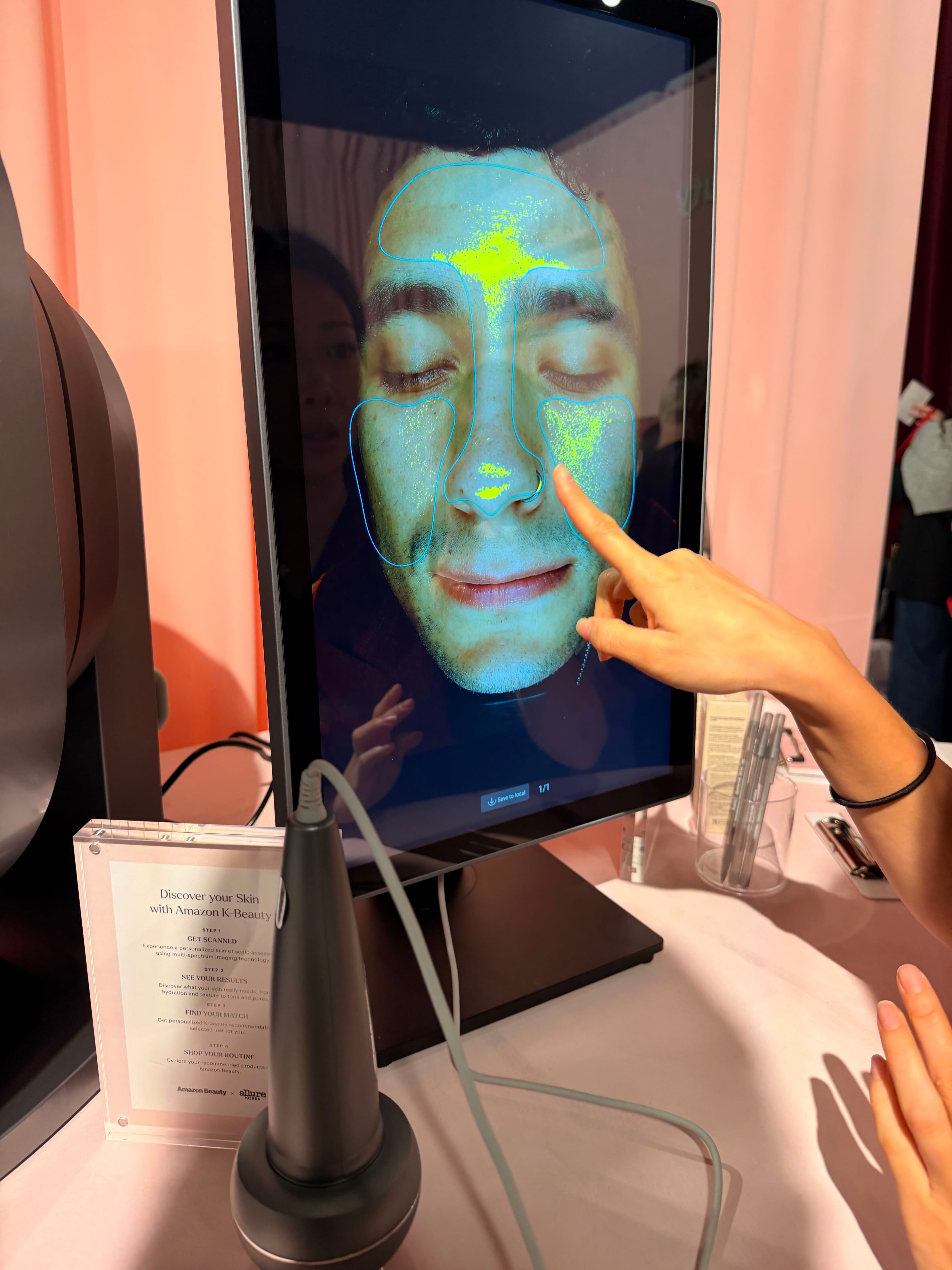 Man looks at his face on a scanner