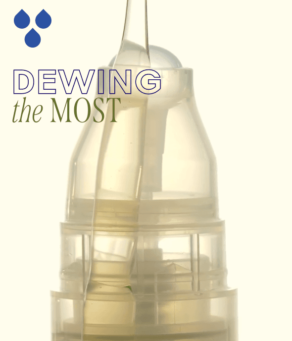 Close-up of a transparent cosmetic bottle with text "DEWING the MOST" and three blue droplets above.