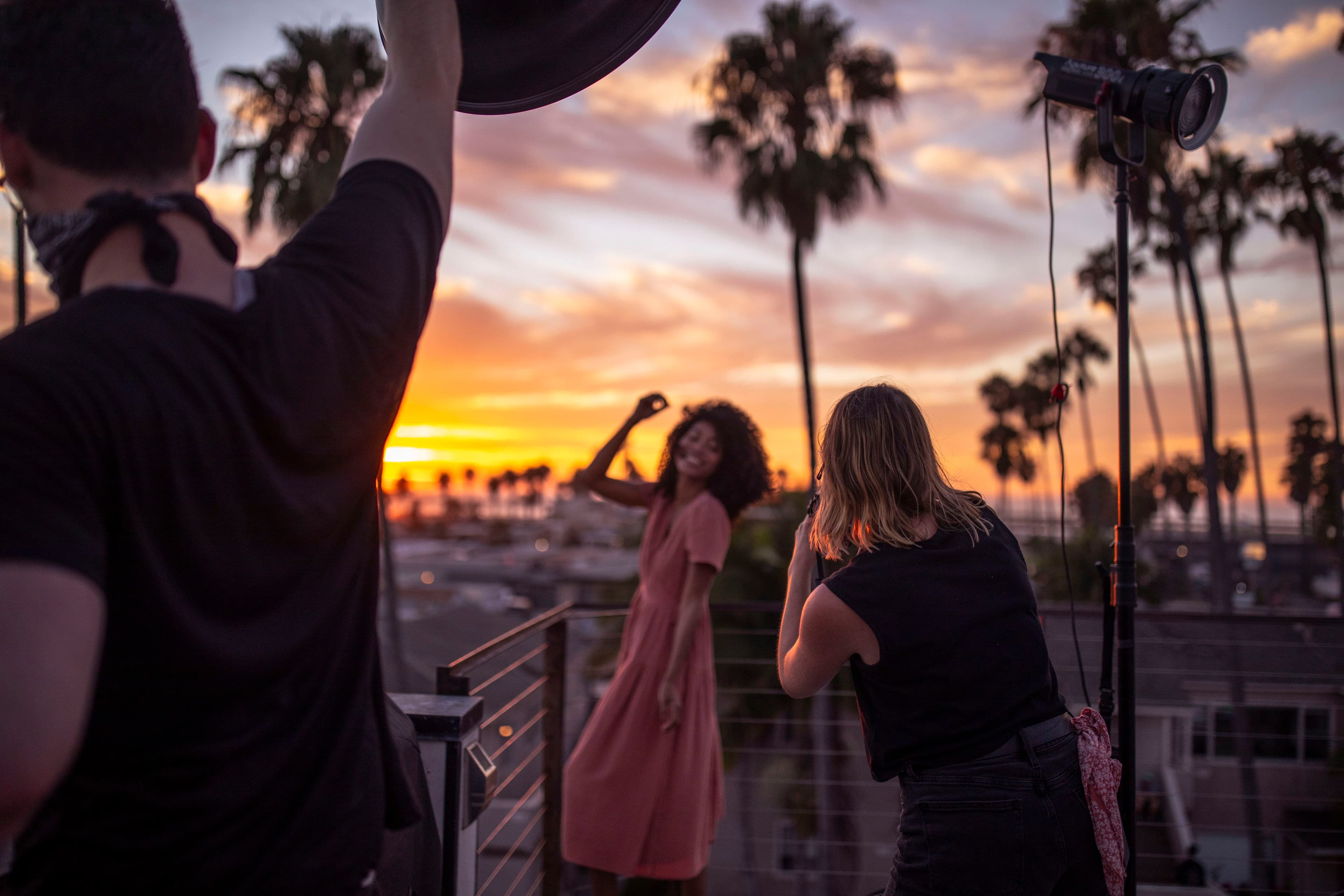 BTS from a shoot in San Diego, model poses for a camera above a rooftop