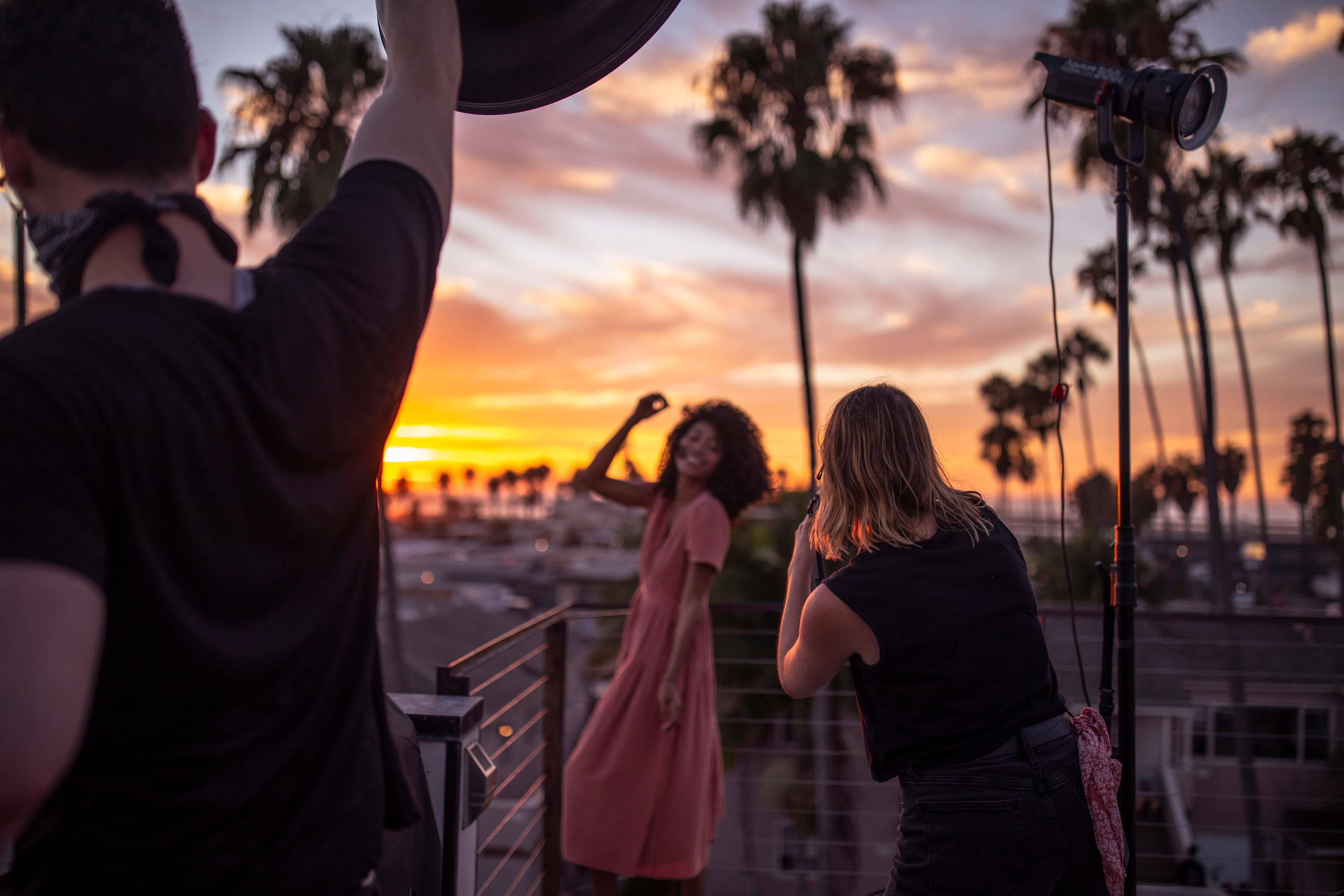 BTS from a shoot in San Diego, model poses for a camera above a rooftop