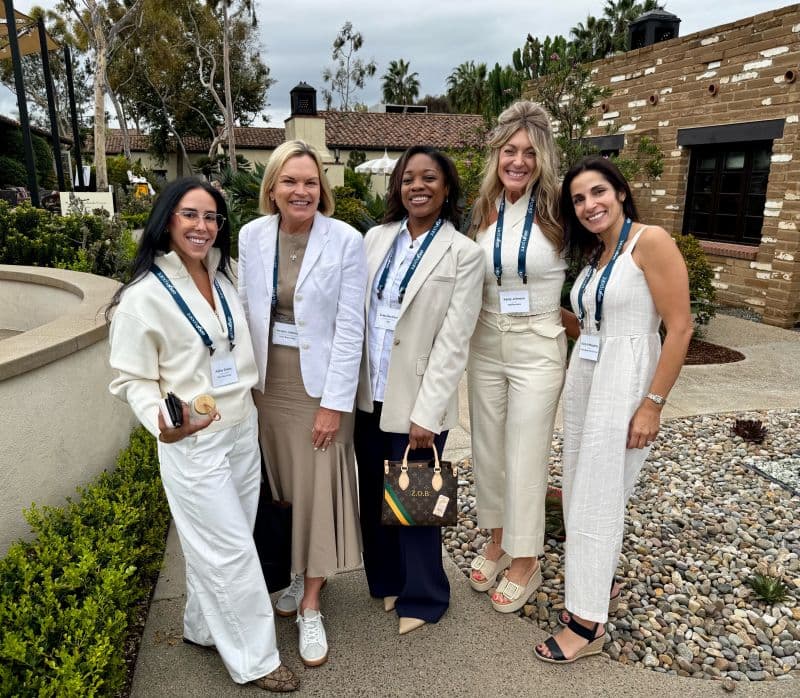 A group of women pose for the camera during the Origin Point wellness conference