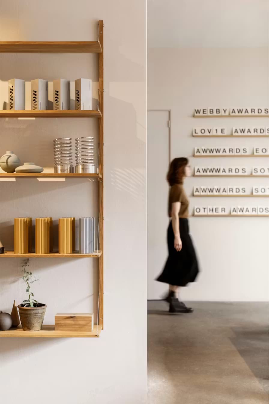 Woman walks in front of an awards section at the BiA office in Amsterdam